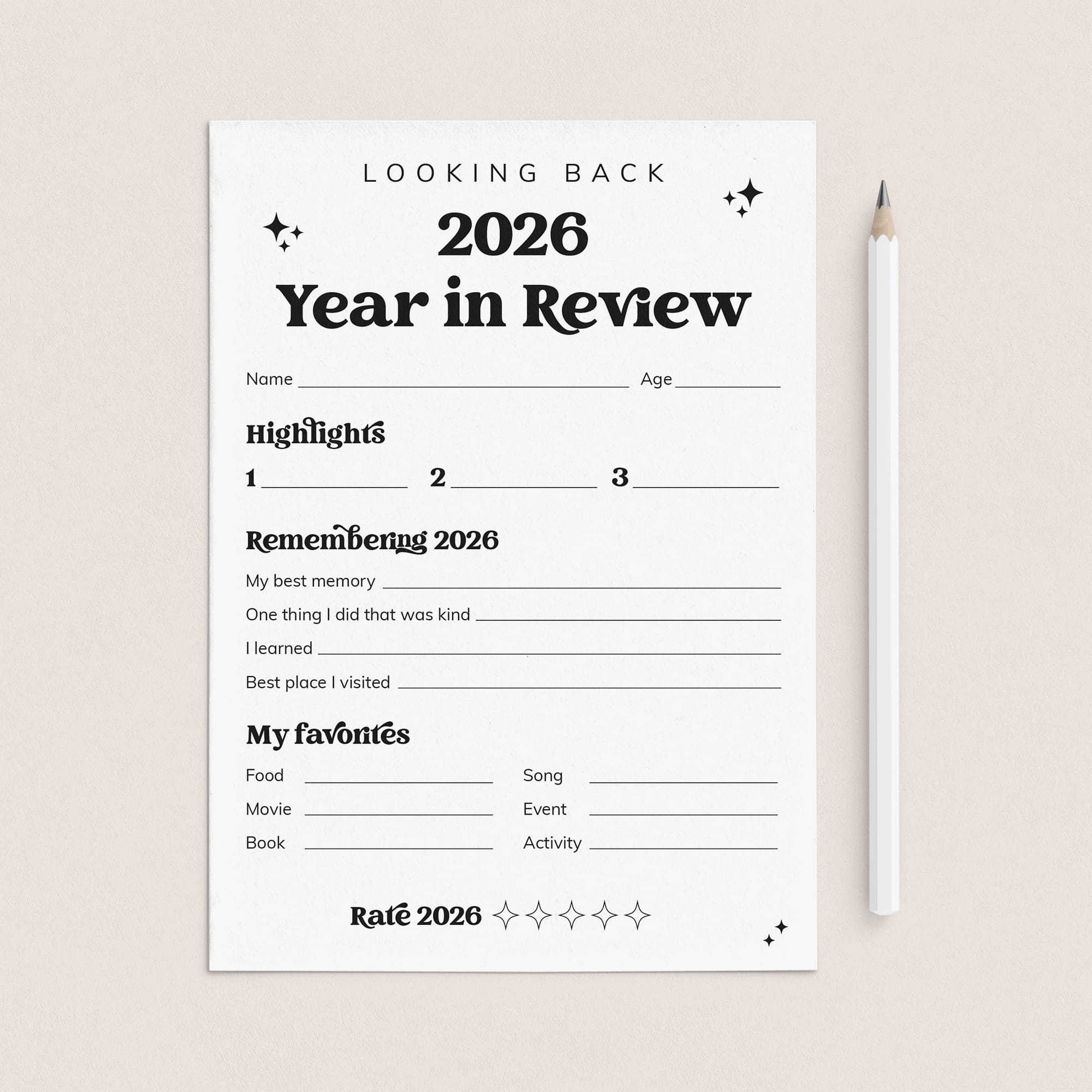 A white '2026 Year in Review' reflection sheet with black text and lines, placed on a light beige background next to a white pencil.