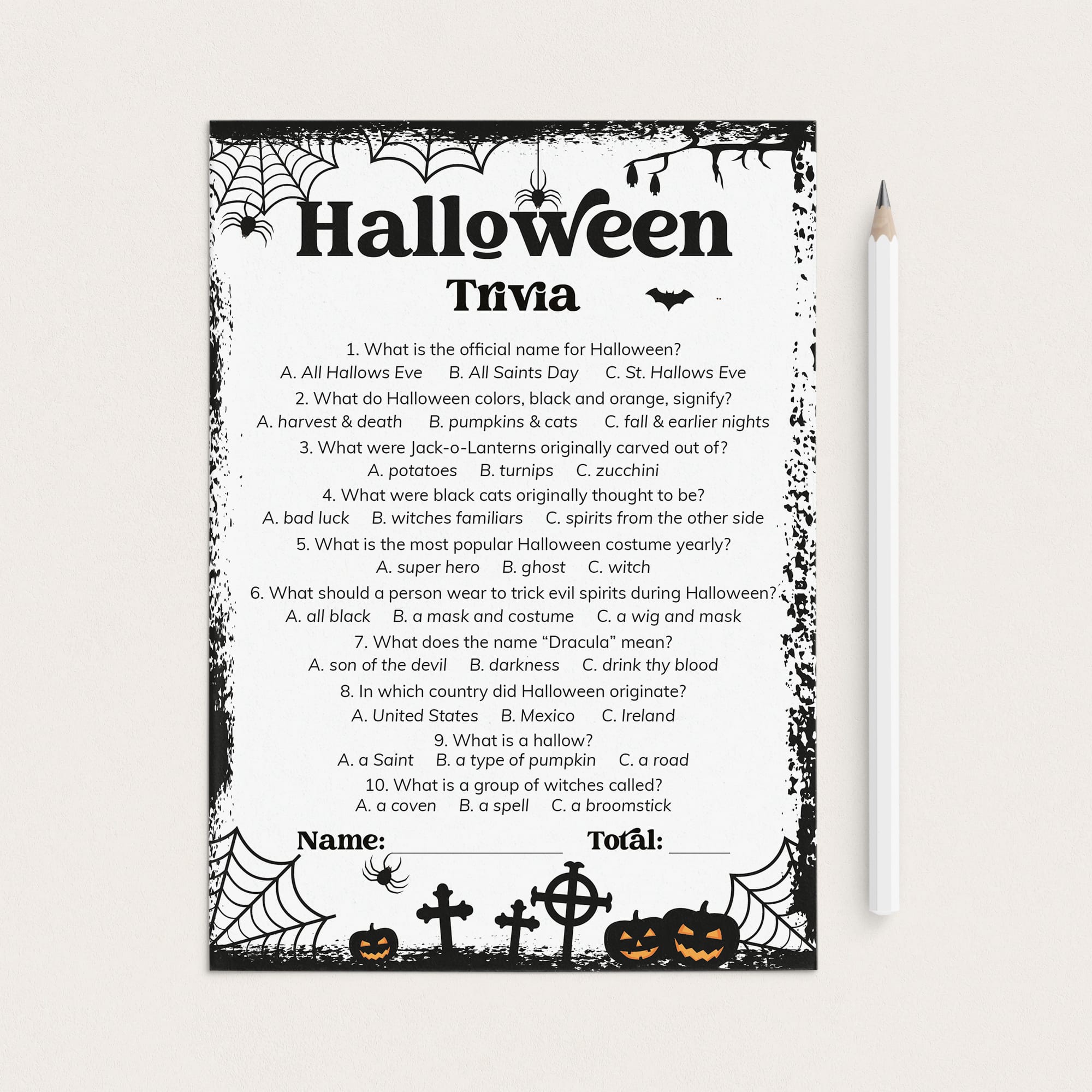 A printable Halloween trivia worksheet with black spiderweb and witch motifs on a white page, shown next to a white pencil on a light beige background.