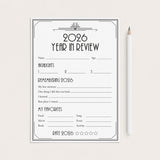 A 2026 Year in Review reflection worksheet with black text and lines on a white sheet, displayed on a light beige background next to a white pencil.