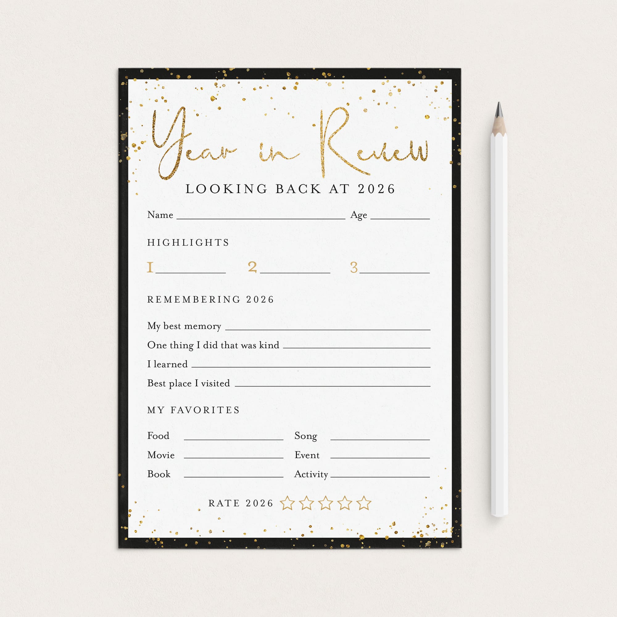 A 'Year in Review' fill-in worksheet template for 2026, featuring a black and gold design, shown flat-lay style next to a white pencil on a light beige background.