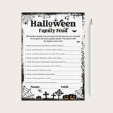 A printable Halloween Family Feud game sheet with black and white spiderweb borders, spooky illustrations, and fill-in lines, shown on a light beige background next to a white pencil.