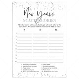 A New Year's Scattergories game card with a white background, black and gray typography, and scattered silver confetti accents in the corners. The card includes blank lines for writing answers and numbered prompts related to resolutions, party attire, drinks, and goals.