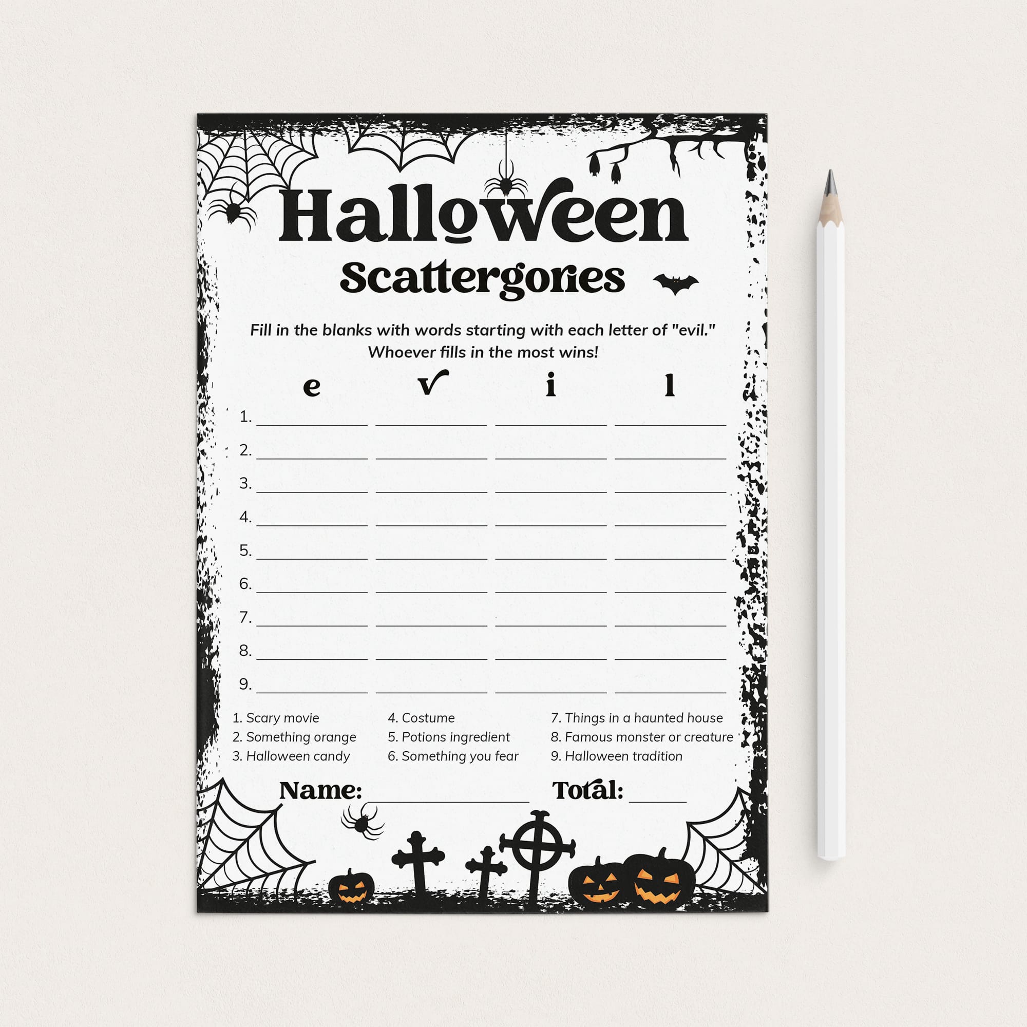 A Halloween-themed printable game card titled 'Halloween Scattergones' with black spiderwebs, bats, pumpkins, crosses, and spooky border graphics on a white sheet, shown next to a white pencil on a light beige background.