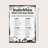 A Halloween-themed phone trivia worksheet with black text and spooky spiderweb, cobwebs, tombstones, and jack-o'-lantern illustrations on a white page, shown on a light beige background with a white pencil beside it.
